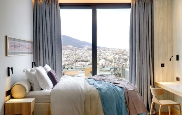 Modern Boulevard Room at COCO-MAT Athens with city view, ideal for business conferences and retreats.