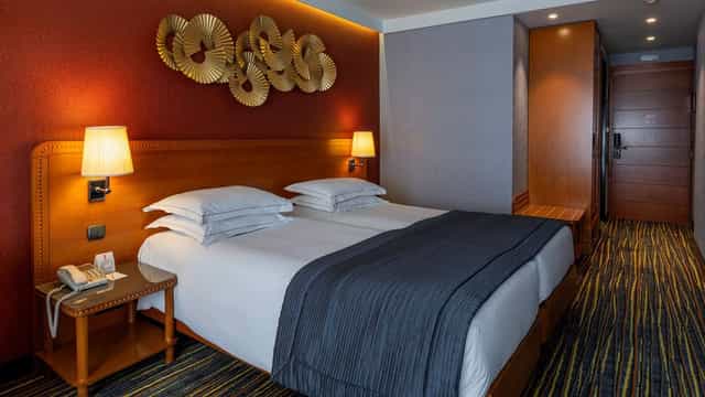 Twin hotel room at ATLAS President Hotel Athens for business group accommodation and events.