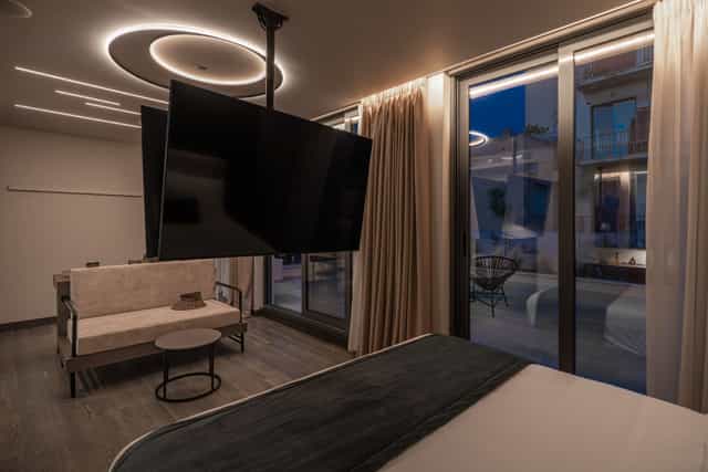 Modern hotel suite with rotating TV for bleisure, executive travel, and business conference stays.