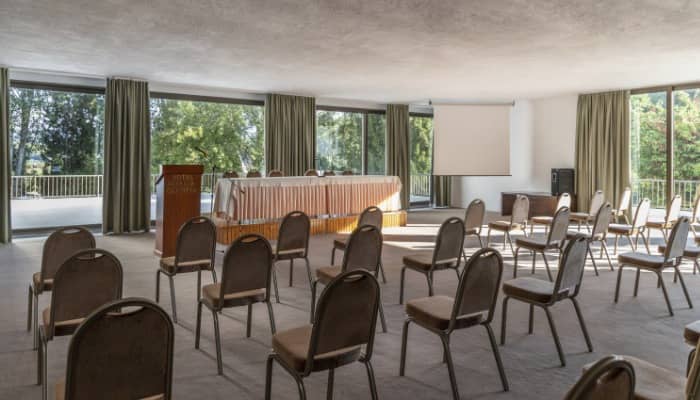 Amalia Athens Hotel theater-style meeting room with terrace access for corporate conferences.