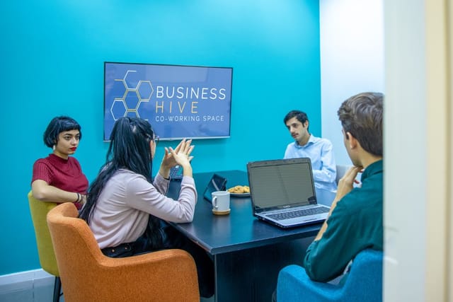 Small breakout room with screen-share setup for collaborative co-working and business meetings.