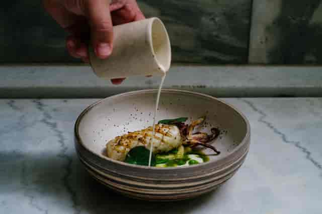 Interactive tableside plating for high-end VIP gala dinner and formal banquet catering.