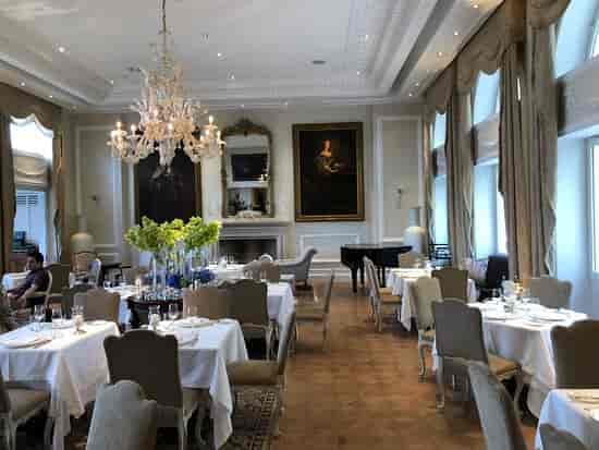 Tudor Hall Restaurant: Elegant gala banquet room with crystal chandelier for corporate events.