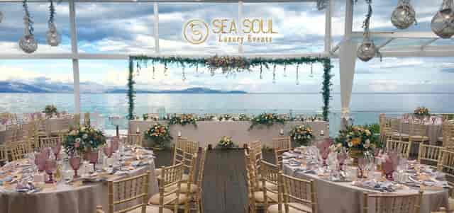 Lefko Sea Soul waterfront wedding setup with elegant floral decor and Chiavari chairs.