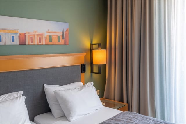 Modern Plaka Hotel room with contemporary decor, ideal for conference accommodation and lodging.