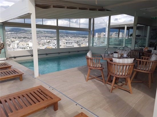 Executive reception pool area at Green Suites Boutique Hotel with panoramic city views.