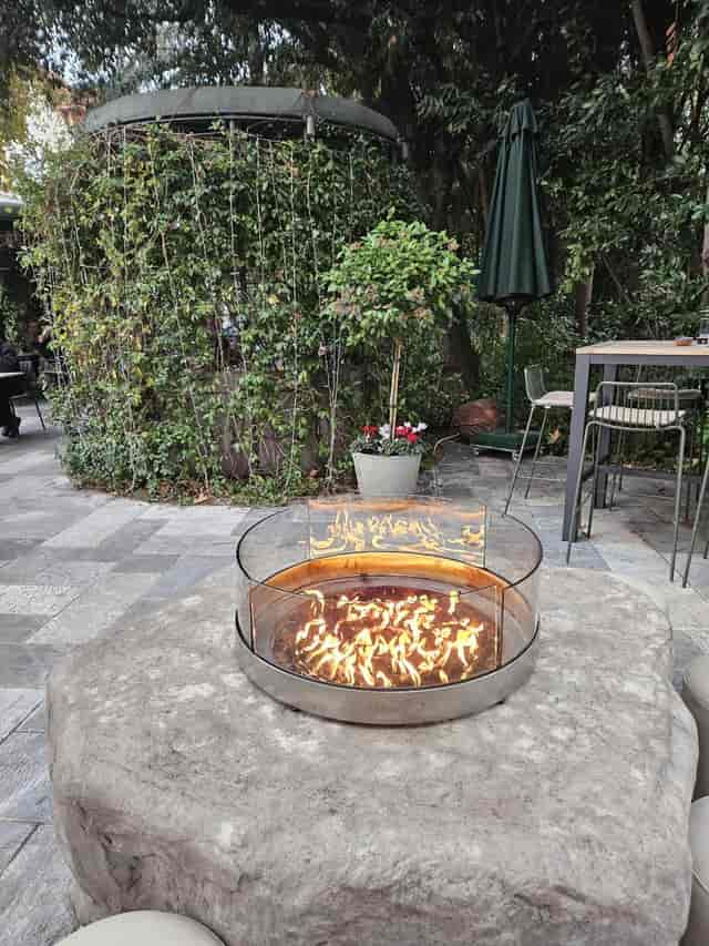 Modern outdoor patio with fire pit at Rick’s American Steakhouse for networking and social events.