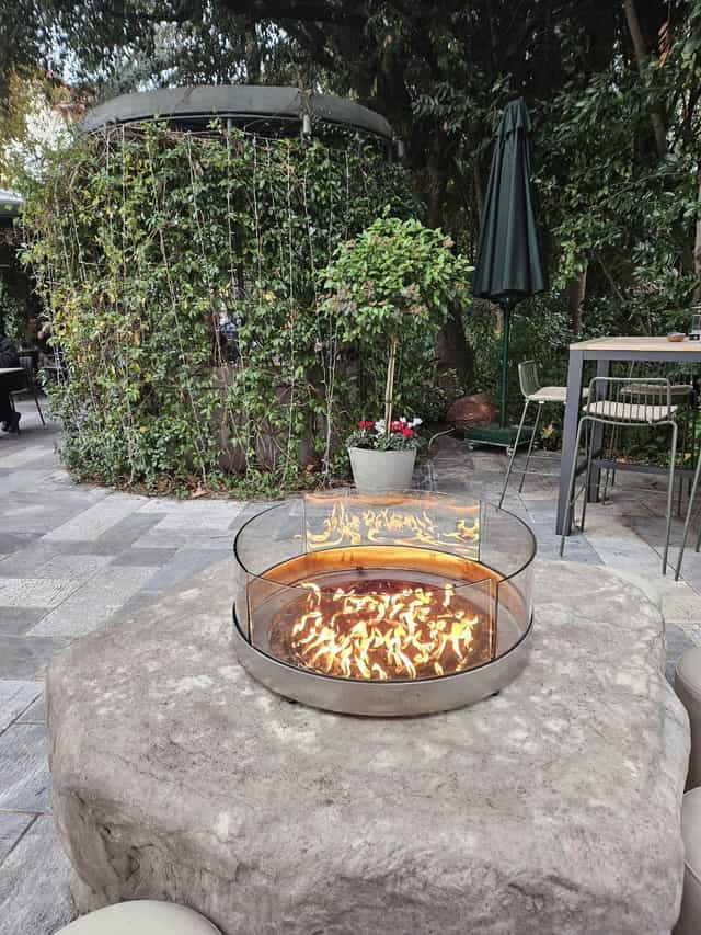Modern outdoor patio with fire pit at Rick’s American Steakhouse for networking and social events.