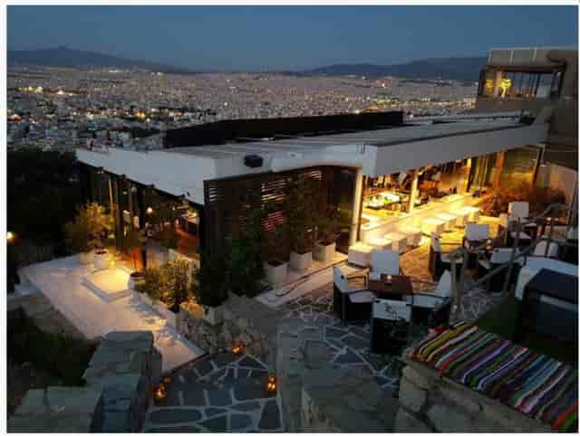 Upscale rooftop corporate cocktail reception at M Bar cafe with panoramic views.