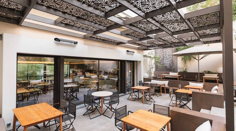 Modular café space with overhead heating for networking events and corporate coffee receptions.
