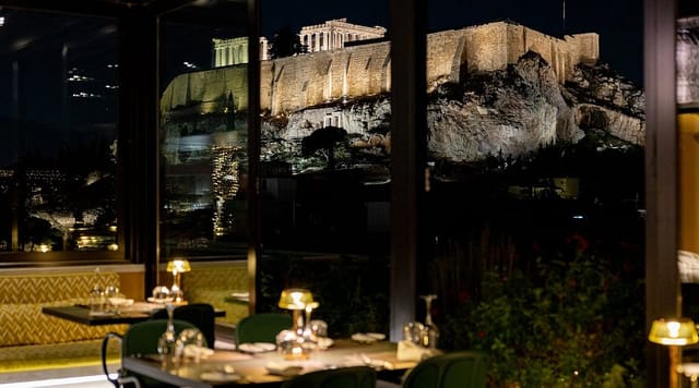 Rooftop restaurant with illuminated Acropolis view, ideal for VIP dinner and executive retreat.