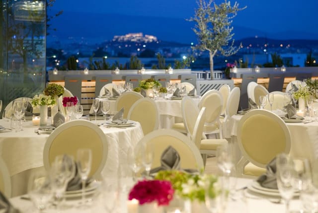 Elegant outdoor gala dinner setup at Eleon Loft with illuminated landmark view.