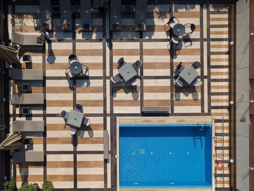 Crowne Plaza Athens rooftop venue featuring pool-side lounge seating for corporate networking events.