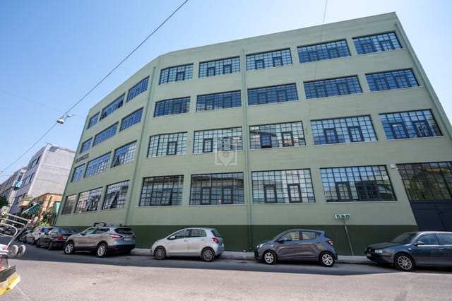 Industrial-chic coworking event space with high ceilings for creative conferences.