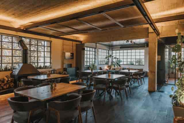 Industrial event venue with natural light for boutique workshops and private executive dinners.