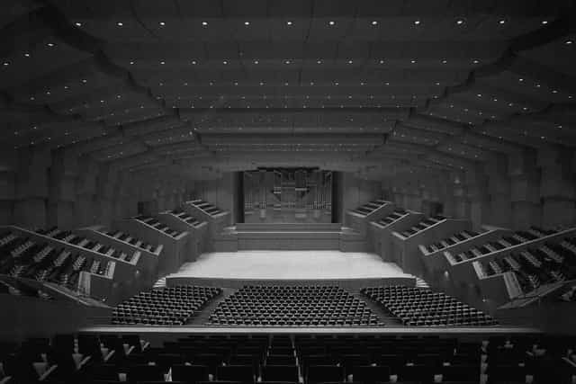 Christos Lambrakis Hall, tiered auditorium stage for professional plenary sessions and keynotes.