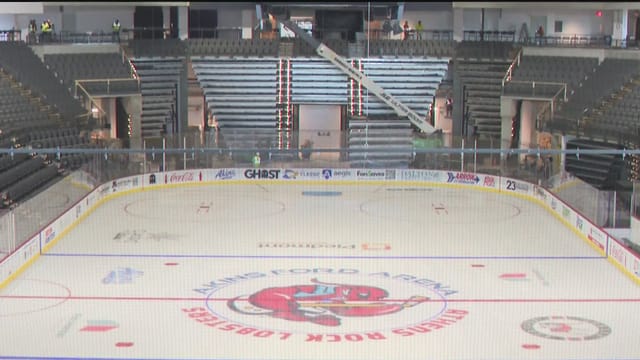 Akins Ford Arena interior during floor conversion for large-scale event production.