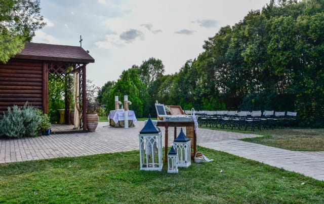 Rustic outdoor garden wedding venue at Polo Club with intimate aisle seating and decor.
