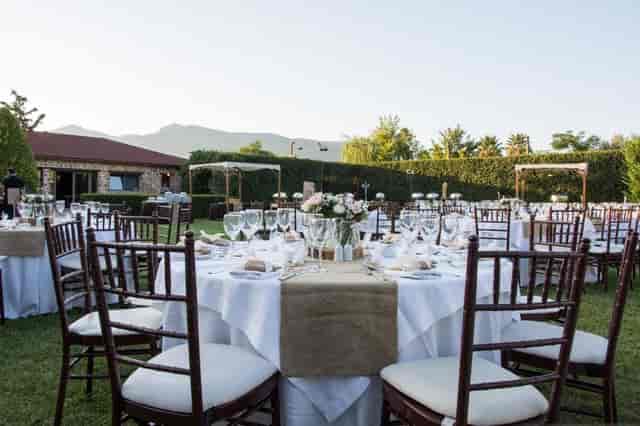 Outdoor banquet at Polo Club with mahogany chairs and mountain views for wedding and gala events.