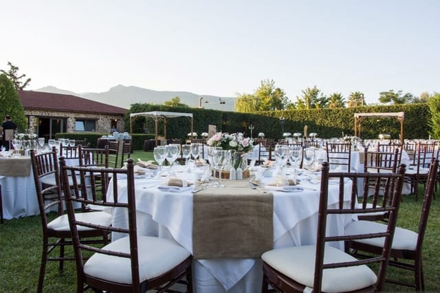Outdoor banquet at Polo Club with mahogany chairs and mountain views for wedding and gala events.