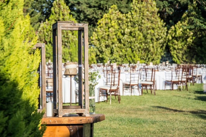 Rustic lantern centerpiece at an elegant garden reception, Polo Club banquet event setup.