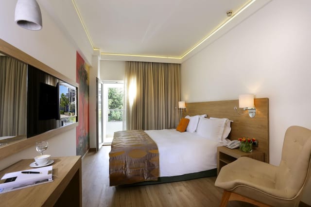 Modern hotel room at Syrene II Golden Age, featuring a dedicated workspace for business travel.