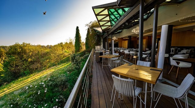 Hytra Restaurant: Elegant outdoor corporate event venue with panoramic skyline views.