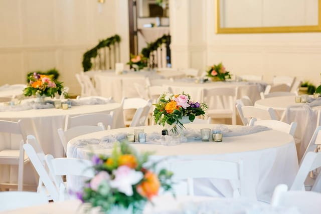 Patio at The Venue on Broad with white-linen round tables for wedding receptions and galas.