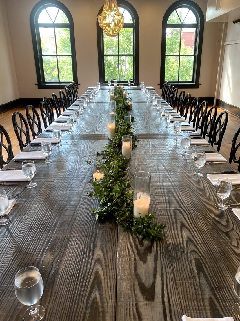 Boardroom dining table with wood decor for corporate dinner or rehearsal event.