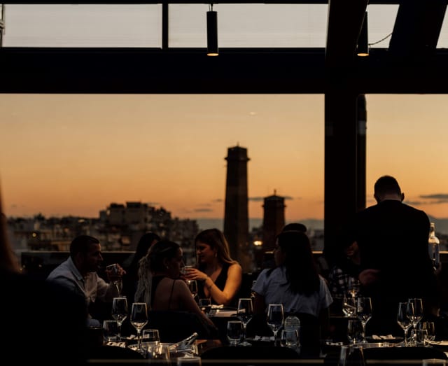 Rooftop cocktail bar at sunset for premium networking reception or corporate incentive dinner.