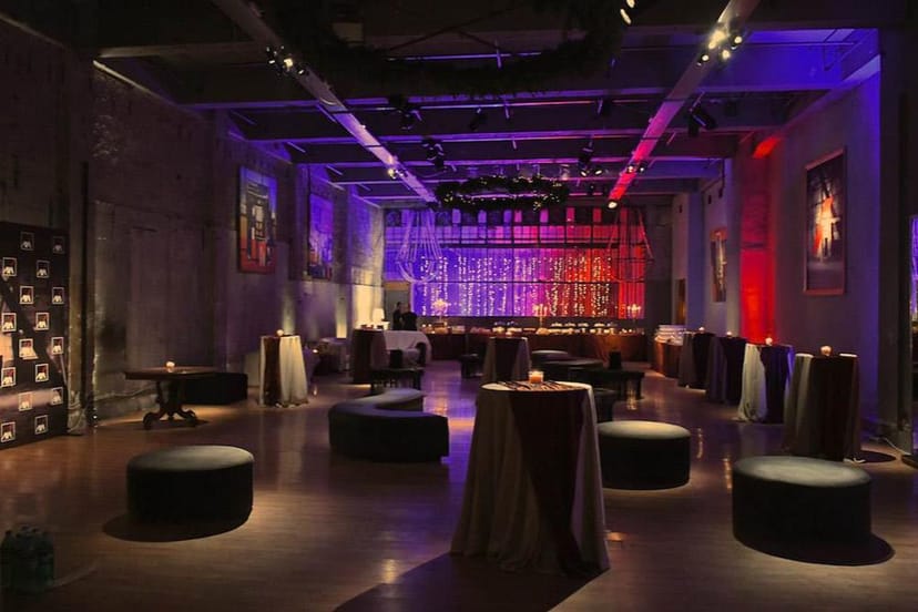 Industrial function room with uplighting for evening networking events and cocktail receptions.