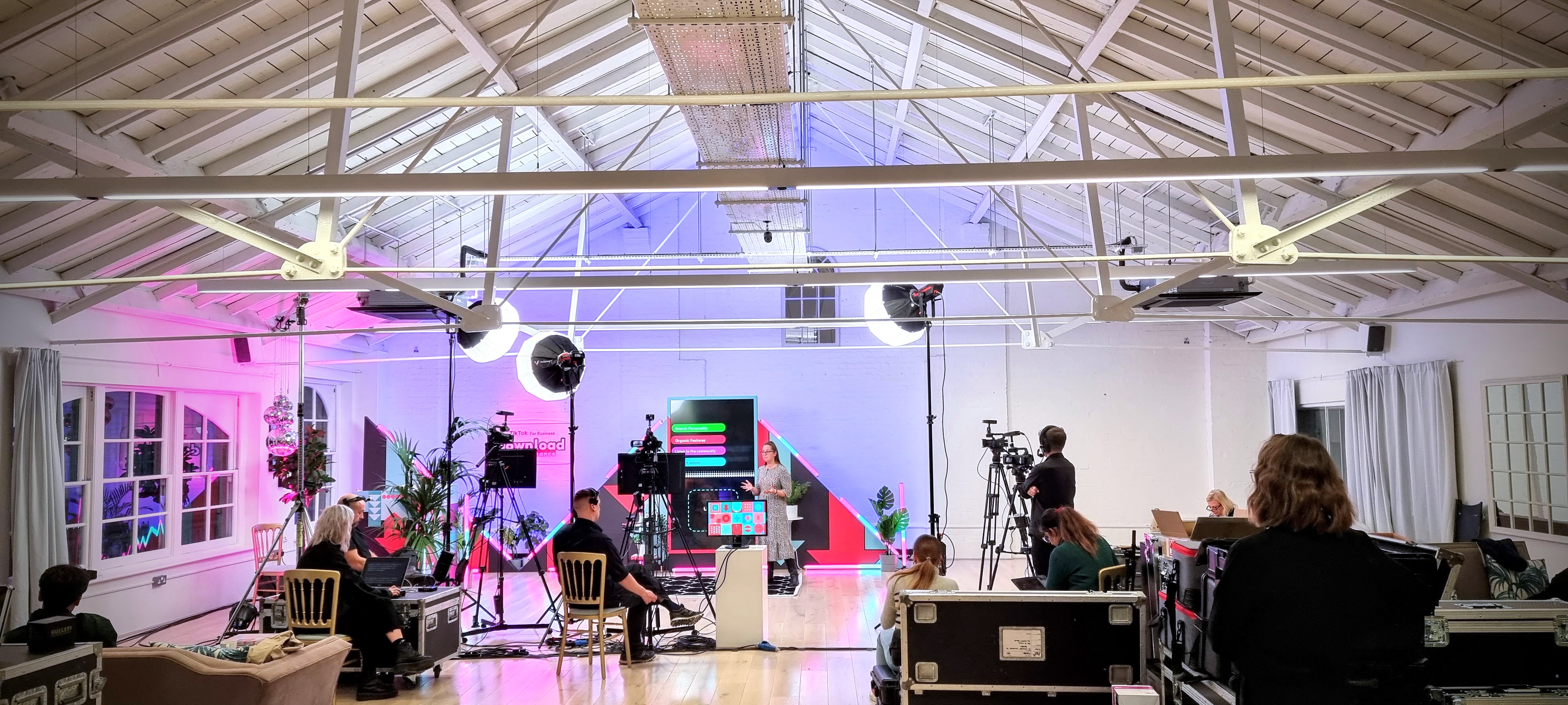 Modern hybrid meeting setup at Underwood Flagship Venue with vibrant backdrop and tech. - Banner