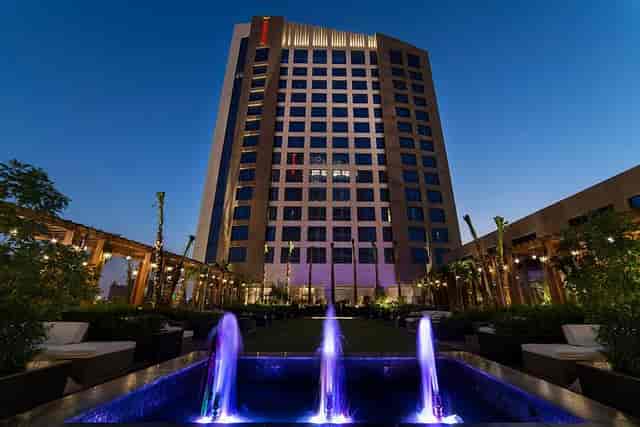 Luxury hotel outdoor pool courtyard for evening cocktail reception and corporate networking event.