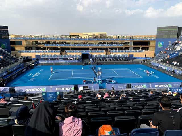 Ardah performance at a Diriyah sports event venue with tiered grandstands and VIP hospitality.