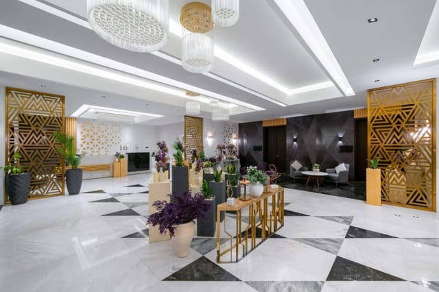 Modern Radisson Blu Riyadh foyer with gold partitions for corporate events and business conferences.
