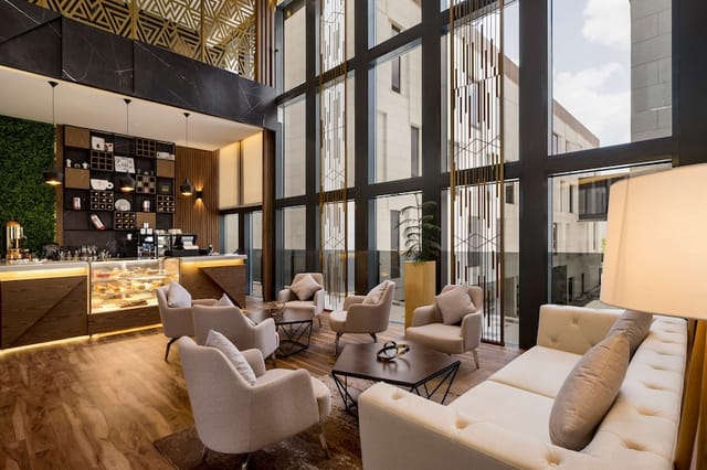 Radisson Blu Riyadh breakout area with tiered seating for corporate networking and events.