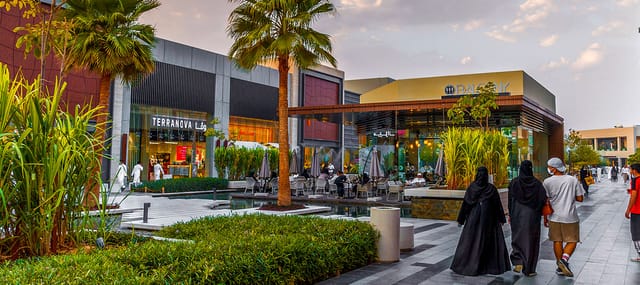Outdoor networking reception at Roshn Business Front with premium seating and water features.