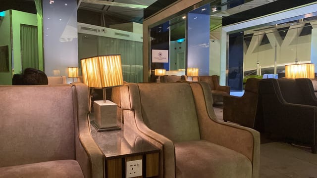 Luxury airport lounge suites with plush seating for business meetings and corporate networking.