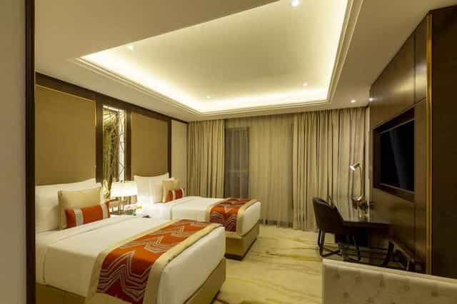 Modern JOUDYAN Hotel executive twin room for business meetings and corporate travel.