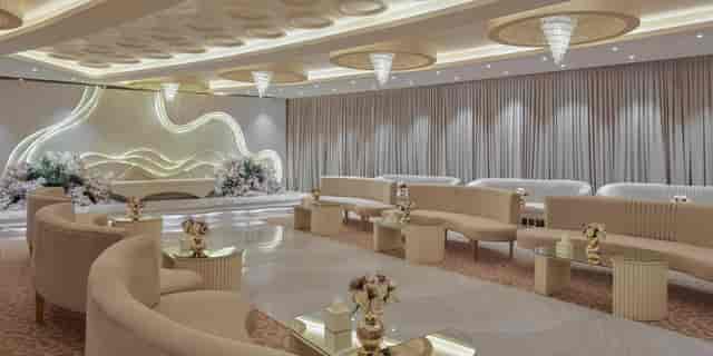 Monochrome Janadriyah Hall ballroom with curved seating for luxury weddings and VIP receptions.