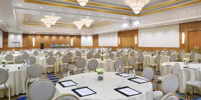Elegant Durrat Ballroom A with round tables, perfect for corporate conferences and gala dinners.