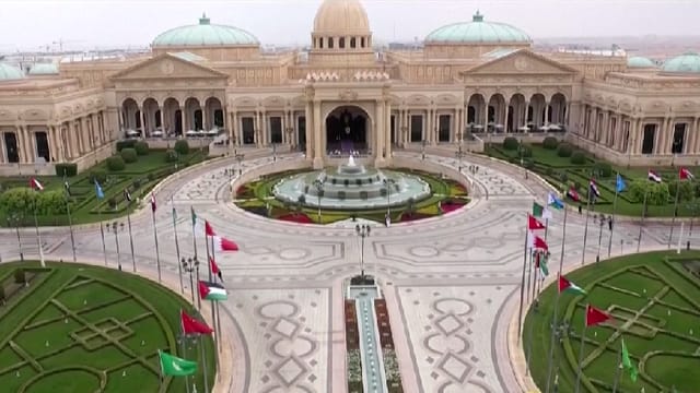 King Abdulaziz International Conference Center hall with flags for diplomatic summits and events.