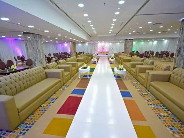 Liali Al Sharq Hall theater setup with central white runway for fashion shows and bridal events.