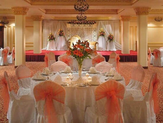 Shams Ballroom at Mövenpick Jeddah with elegant tiered stage drapery for weddings and events.