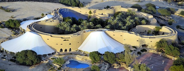 Main Lounge at Tuwaiq Palace, organic desert architecture for corporate retreats and luxury events.