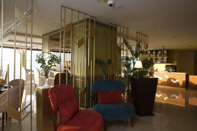 Upscale lobby lounge with gold partitions, perfect for business networking and corporate meetings.