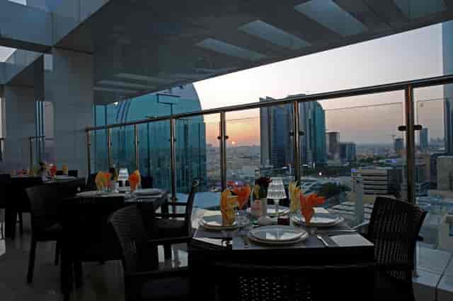 Rooftop restaurant at Cantonal Hotel Riyadh with sunset city views for upscale networking events.