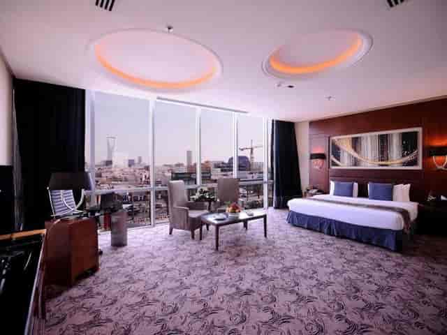 Luxury hotel executive suite with workspace and Riyadh skyline view for VVIP meetings and events.
