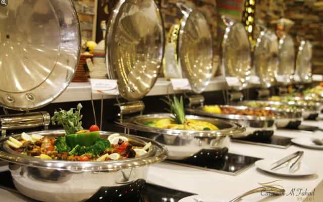 Buffet service in Al Fahad Hotel restaurant featuring polished stainless steel for corporate events.