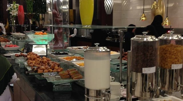 Al Ruwad hotel breakfast buffet with fresh pastries and drink stations for event catering.